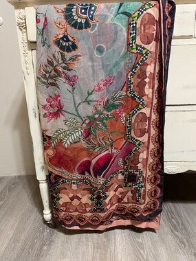 Decorative silk scarf featuring an intricate floral and paisley-inspired design